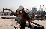 A French soldier carries a bag of rice as French forces aid the Lebanese army's work at the damaged site of the massive blast in Beirut's port area, in Beirut on August 31, 2020. (Gonzalo Fuentes/Pool/AFP)