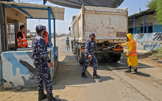 A municipal worker disinfects a truck at a checkpoint in Rafah in the southern Gaza Strip on August 31, 2020. (SAID KHATIB / AFP)