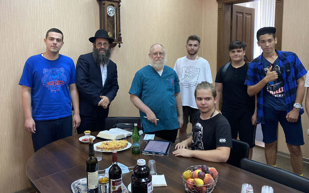 Rabbi Chaim Danzinger, left, introduces Dr. Yeshaya Shafit, second from left, to Jews awaiting circumcision at the synagogue of Rostov-on-Don in Russia, July 27, 2020. (Courtesy of the Jewish Community of Rostov/ via JTA) Rabbi Chaim Danzinger, left, introduces Dr. Yeshaya Shafit, second from left, to Jews awaiting circumcision at the synagogue of Rostov-on-Don in Russia, July 27, 2020. (Courtesy of the Jewish Community of Rostov/ via JTA)