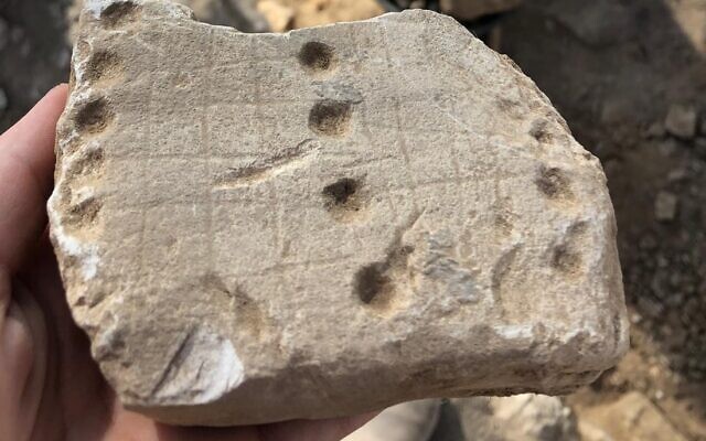 A game board called 'Hounds and Jackals,' or '58 Holes,' found during IAA excavations in Rahat, a Beduin city in the Negev Desert. (Emil Aladjem/Israel Antiquities Authority)