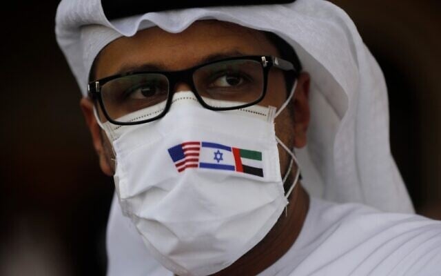 A man wearing a mask bearing the national flags of America, Israel and United Arab Emirates, watches a ceremony after an El Al plane from Israel landed in Abu Dhabi, United Arab Emirates, Aug. 31, 2020. Nir Elias/Pool via AP) A man wearing a mask bearing the national flags of America, Israel and United Arab Emirates, watches a ceremony after an El Al plane from Israel landed in Abu Dhabi, United Arab Emirates, Aug. 31, 2020. Nir Elias/Pool via AP)