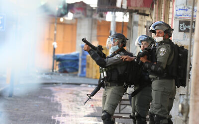 Soldiers fire tear gas in Hebron on August 28, 2020. (WAFA)