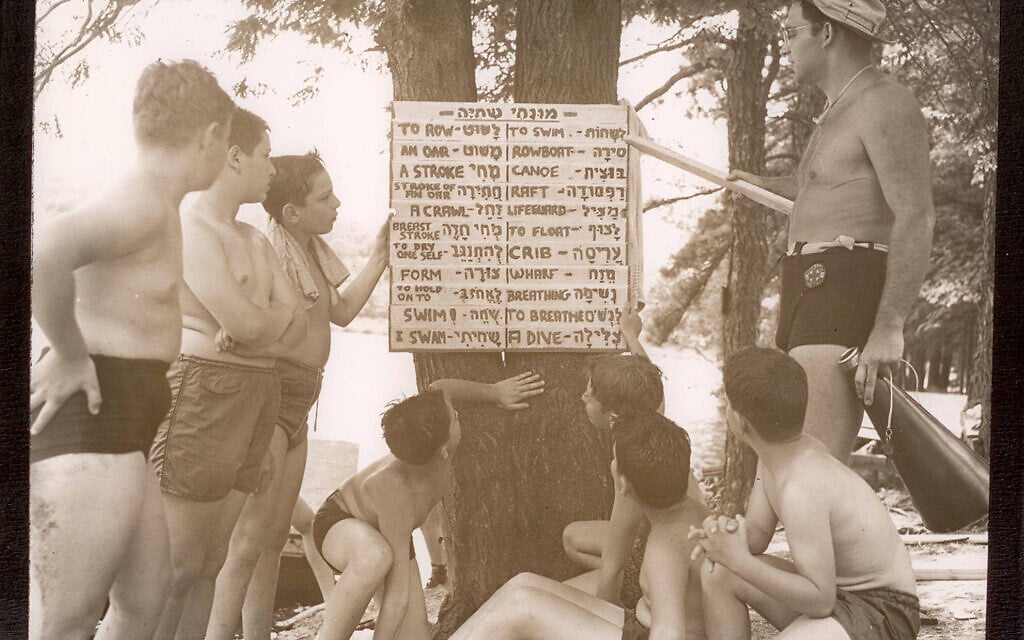 Massad campers and staff consult a placard with Hebrew waterfront vocabulary. (Courtesy of Camp Massad Alumni Association and Elena Neuman Lefkowitz)