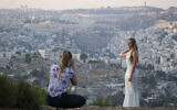 Illustrative: An Israeli woman in a wedding dress is photographed with a view of the Old City of Jerusalem in the background. (Hadas Parush/Flash90)