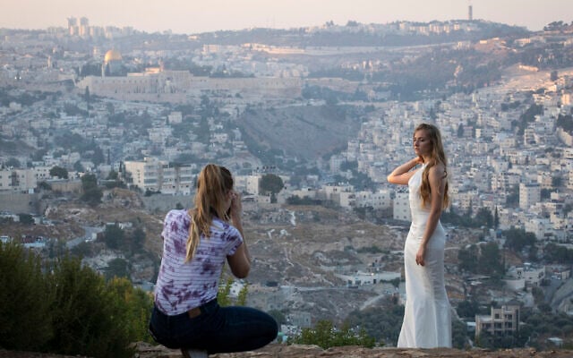 Illustrative: An Israeli woman in a wedding dress is photographed with a view of the Old City of Jerusalem in the background. (Hadas Parush/Flash90) Illustrative: An Israeli woman in a wedding dress is photographed with a view of the Old City of Jerusalem in the background. (Hadas Parush/Flash90)