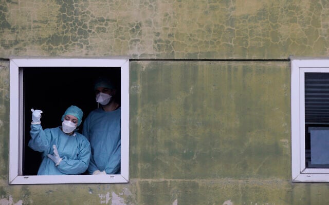Medical staff in work at one of the emergency structures that were set up to ease procedures at the Brescia hospital, northern Italy, March 12, 2020. (AP Photo/Luca Bruno) Medical staff in work at one of the emergency structures that were set up to ease procedures at the Brescia hospital, northern Italy, March 12, 2020. (AP Photo/Luca Bruno)