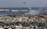 A Lebanese army helicopter drops water at the scene where an explosion hit the seaport of Beirut, Lebanon, August 5, 2020. (Hussein Malla/AP)