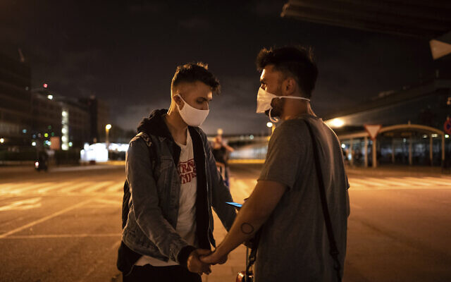 Piotr Grabarczyk and his boyfriend Kamil Pawlik, right, from Poland, wait for a taxi outside the airport after Grabarczyk arrived in Barcelona, Spain, early July 29, 2020.(AP Photo/Felipe Dana) Piotr Grabarczyk and his boyfriend Kamil Pawlik, right, from Poland, wait for a taxi outside the airport after Grabarczyk arrived in Barcelona, Spain, early July 29, 2020.(AP Photo/Felipe Dana)