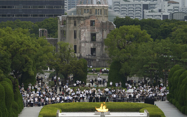 Visitors observe a minute of silence for the victims of the atomic bombing, at 8:15 a.m., the time atomic bomb exploded over the city, at the Hiroshima Peace Memorial Park during the ceremony to mark the 75th anniversary of the bombing, August 6, 2020, in Hiroshima, western Japan. (AP Photo/Eugene Hoshiko) Visitors observe a minute of silence for the victims of the atomic bombing, at 8:15 a.m., the time atomic bomb exploded over the city, at the Hiroshima Peace Memorial Park during the ceremony to mark the 75th anniversary of the bombing, August 6, 2020, in Hiroshima, western Japan. (AP Photo/Eugene Hoshiko)