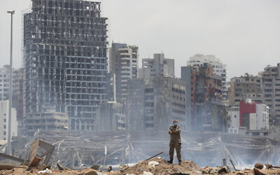 A soldier stands at the devastated site of the explosion in the port of Beirut, Lebanon, Thursday, Aug. 6, 2020 (AP Photo/Thibault Camus, Pool)