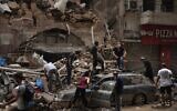 People remove debris from a house damaged by Tuesday's explosion in the seaport of Beirut, Lebanon, Friday, Aug. 7, 2020 (AP Photo/Felipe Dana)