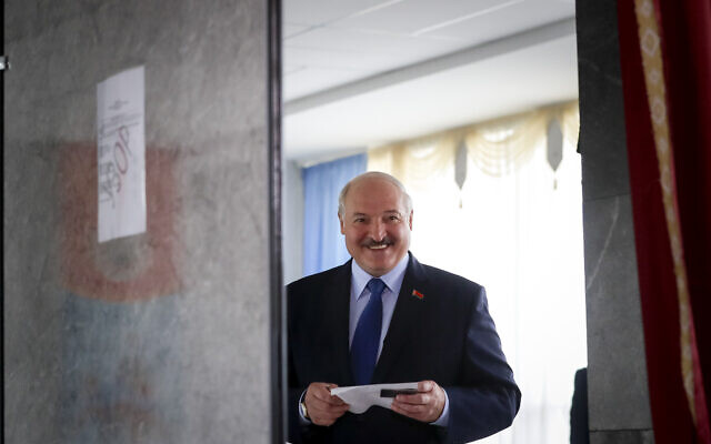 Belarusian President Alexander Lukashenko reacts as he walks to cast his ballot at a polling station during the presidential election in Minsk, Belarus, Sunday, August 9, 2020. (AP Photo/Sergei Grits) Belarusian President Alexander Lukashenko reacts as he walks to cast his ballot at a polling station during the presidential election in Minsk, Belarus, Sunday, August 9, 2020. (AP Photo/Sergei Grits)
