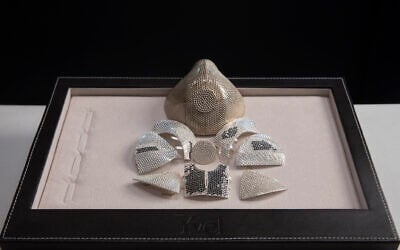 Parts and a model of a mask are displayed by the Israeli jewelry company Yvel in Motza near Jerusalem, August 9, 2020. (AP Photo/ Sebastian Scheiner)