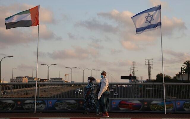Women wearing face masks against the coronavirus walk past United Arab Emirates and Israeli flags at the Peace Bridge in Netanya, Israel, August 16, 2020. (AP Photo/Ariel Schalit) Women wearing face masks against the coronavirus walk past United Arab Emirates and Israeli flags at the Peace Bridge in Netanya, Israel, August 16, 2020. (AP Photo/Ariel Schalit)