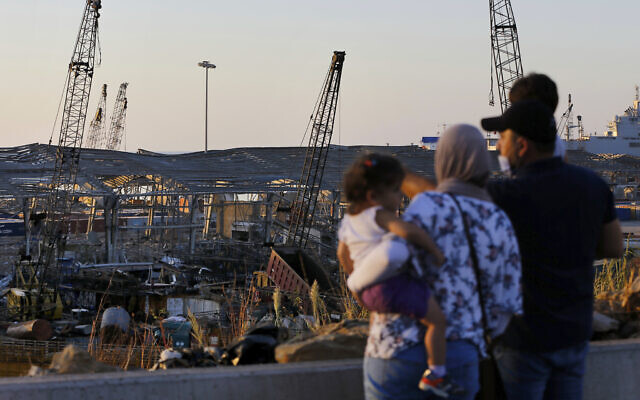 A family looks at the aftermath of the site of the August 4 explosion that hit the seaport of Beirut, Lebanon, August 16, 2020. (AP Photo/Bilal Hussein) A family looks at the aftermath of the site of the August 4 explosion that hit the seaport of Beirut, Lebanon, August 16, 2020. (AP Photo/Bilal Hussein)
