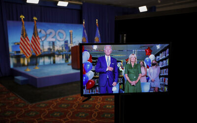Democratic presidential candidate former Vice President Joe Biden is seen in a video feed from Delaware with his wife Jill Biden, and his grandchildren at his side, after winning the votes to become the Democratic Party's 2020 nominee for President, during the second night of the virtual 2020 Democratic National Convention in Milwaukee, Wisc., Tuesday, Aug. 18, 2020. (Brian Snyder/Pool via AP)