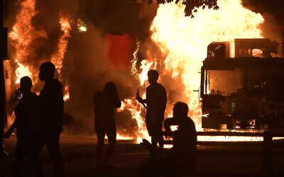 Garbage and dump trucks set ablaze by rioters near the Kenosha County Courthouse in Kenosha, Wisoncin, August 23, 2020. (Sean Krajacic/Kenosha News via AP)