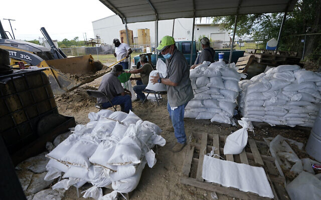 Municipal workers fill sandbags for the elderly and those with disabilities ahead of Hurricane Laura in Crowley, Louisiana, August 25, 2020. (AP Photo/Gerald Herbert) Municipal workers fill sandbags for the elderly and those with disabilities ahead of Hurricane Laura in Crowley, Louisiana, August 25, 2020. (AP Photo/Gerald Herbert)