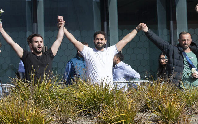 Mosque shooting survivors from left, Mustafa Boztas, Wassail Daragmih and Temel Atacocugu celebrate as they leave the Christchurch High Court after the sentencing hearing for Australian Brenton Harrison Tarrant, in Christchurch, New Zealand, August 27, 2020. (AP Photo/Mark Baker) Mosque shooting survivors from left, Mustafa Boztas, Wassail Daragmih and Temel Atacocugu celebrate as they leave the Christchurch High Court after the sentencing hearing for Australian Brenton Harrison Tarrant, in Christchurch, New Zealand, August 27, 2020. (AP Photo/Mark Baker)