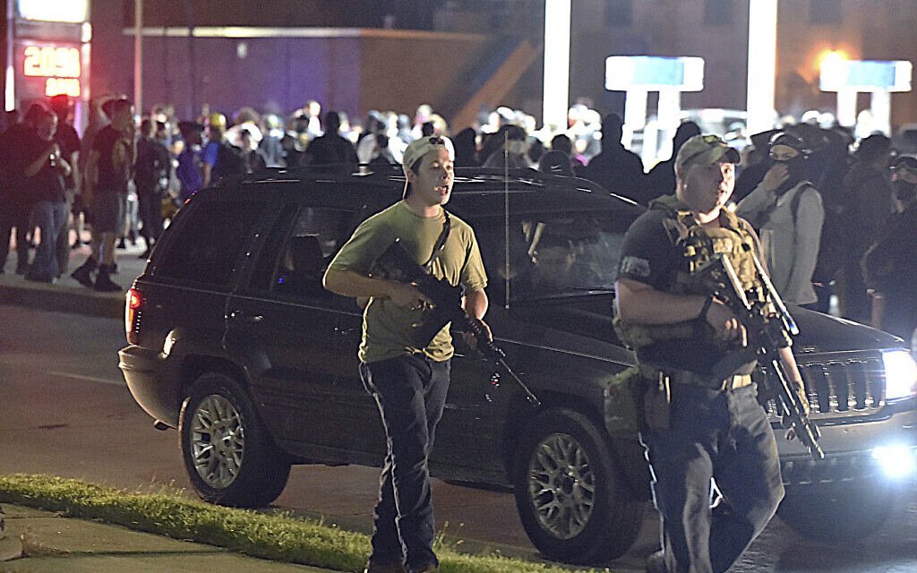 Kyle Rittenhouse, left, with backwards cap, walks along Sheridan Road in Kenosha, Wisconsin, August 25, 2020, with another armed civilian. (Adam Rogan/The Journal Times via AP) Kyle Rittenhouse, left, with backwards cap, walks along Sheridan Road in Kenosha, Wisconsin, August 25, 2020, with another armed civilian. (Adam Rogan/The Journal Times via AP)