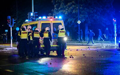 Demonstrators throw stones at police as protesters riot in the Rosengard neighborhood of Malmo, Sweden, August 28, 2020. (TT News Agency via AP)