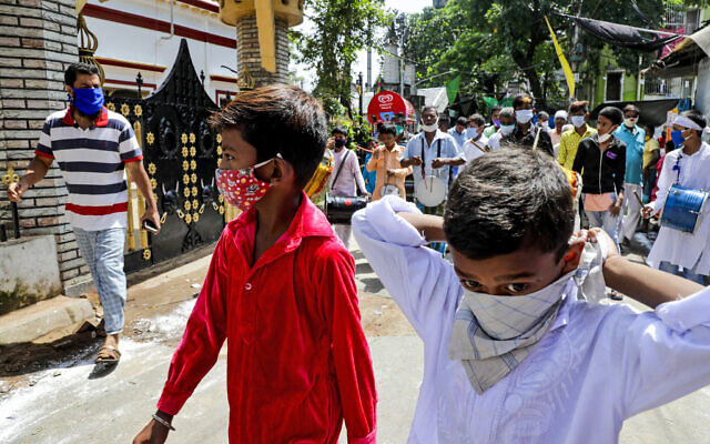 Muslims wearing face masks beat drums as they take part in a Muharram procession in Kolkata, India on August 30, 2020. (AP/ Bikas Das) Muslims wearing face masks beat drums as they take part in a Muharram procession in Kolkata, India on August 30, 2020. (AP/ Bikas Das)