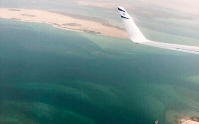 A wing tip with the Star of David is visible through the window of an Israeli El Al airliner just before the plane lands in Abu Dhabi, United Arab Emirates, Monday, Aug. 31, 2020.  (Nir Elias/Pool Photo via AP)