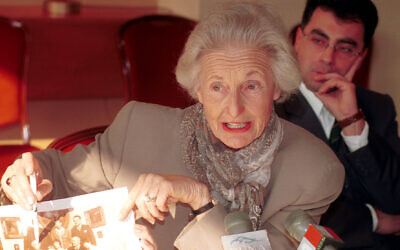 American-Hungarian dual citizen Martha Nierenberg shows an old family photo during a press conference in the Hotel Intercontinental in Budapest, October 24, 2000. (MTI/Tibor Rozsahegyi/ AP)