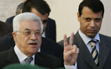 Palestinian Authority President Mahmoud Abbas flashes the V-sign as Fatah leader Mohammed Dahlan looks on after their meeting with British Prime Minister Tony Blair at his office in the West Bank town of Ramallah, December 18, 2006. (AP Photo/Kevin Frayer/File)