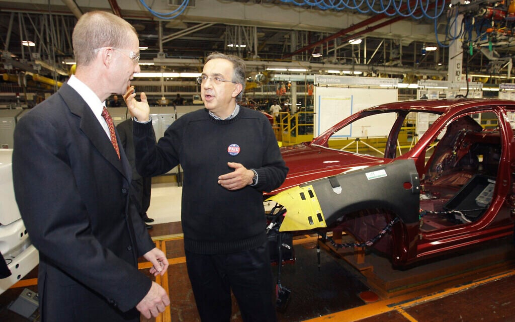 Illustrative: Chrysler Group CEO Sergio Marchionne, right, and Ron Bloom, then-assistant to former president Barack Obama for manufacturing policy walk on the assembly line at the Sterling Heights Assembly Plant in Sterling Heights, Michigan, May 24, 2011. (AP Photo/Carlos Osorio)