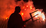 Illustrative: A man dressed as a devil performs in front of a giant fire during the Walpurgis night in Erfurt, central Germany, Sunday, April 30, 2017. (AP Photo/Jens Meyer)