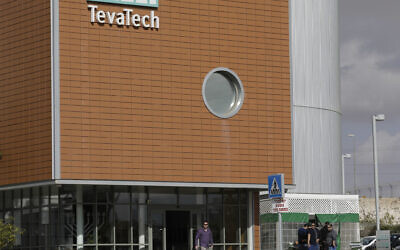 A man walks out of Teva Pharmaceutical facility building in Neot Hovav, Israel, Thursday, Dec. 14, 2017. (AP Photo/Tsafrir Abayov)