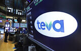 The logo for Teva appears above a trading post on the floor of the New York Stock Exchange, October 21, 2019.  (AP Photo/ Richard Drew)