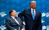 US President Donald Trump, right, pats Las Vegas Sands Corporation Chief Executive and Republican mega donor Sheldon Adelson on the arm, before speaking at the Israeli American Council National Summit in Hollywood, Florida, December 7, 2019. (Patrick Semansky/AP)