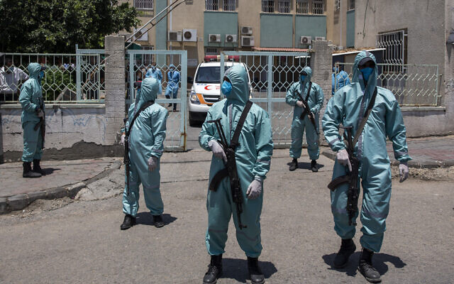 Palestinian Hamas police officers wear protective suits as they take part in a simulation of possible coronavirus infections in Gaza City, Saturday, July 18, 2020. (AP/Khalil Hamra) Palestinian Hamas police officers wear protective suits as they take part in a simulation of possible coronavirus infections in Gaza City, Saturday, July 18, 2020. (AP/Khalil Hamra)