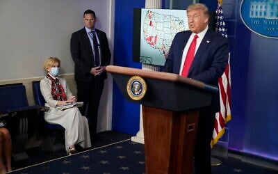 White House coronavirus response coordinator Dr. Deborah Birx, left, listens as US President Donald Trump speaks during a news conference at the White House, July 23, 2020, in Washington. (Evan Vucci/AP)