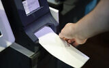 In this June 13, 2019 file photo, an Investigator with the Office of the City Commissioners, demonstrates the ExpressVote XL voting machine at the Reading Terminal Market in Philadelphia (AP Photo/Matt Rourke, File)