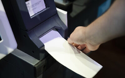 In this June 13, 2019 file photo, an Investigator with the Office of the City Commissioners, demonstrates the ExpressVote XL voting machine at the Reading Terminal Market in Philadelphia (AP Photo/Matt Rourke, File)