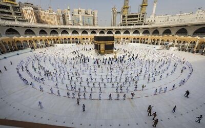 Pilgrims walk around the Kabba at the Grand Mosque, in the Muslim holy city of Mecca, Saudi Arabia, Friday, July 31, 2020.  (Saudi Ministry of Media via AP)