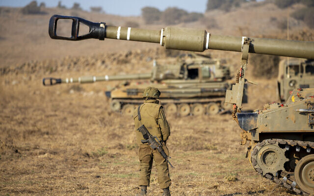 An Israeli soldier stands next to a mobile artillery unit during an exercise in the Golan Heights on August 4, 2020. (Ariel Schalit/AP) An Israeli soldier stands next to a mobile artillery unit during an exercise in the Golan Heights on August 4, 2020. (Ariel Schalit/AP)