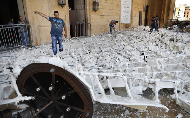 People remove debris from a damaged mosque a day after an explosion hit the seaport of Beirut, Lebanon, August 5, 2020. (AP Photo/Hussein Malla) People remove debris from a damaged mosque a day after an explosion hit the seaport of Beirut, Lebanon, August 5, 2020. (AP Photo/Hussein Malla)