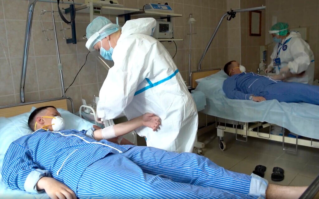 Medical workers draw blood from volunteers participating in a trial of a coronavirus vaccine at the Budenko Main Military Hospital outside Moscow, Russia, July 15, 2020. (Russian Defense Ministry Press Service via AP) Medical workers draw blood from volunteers participating in a trial of a coronavirus vaccine at the Budenko Main Military Hospital outside Moscow, Russia, July 15, 2020. (Russian Defense Ministry Press Service via AP)