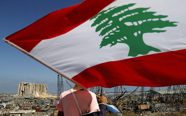 A man holds the Lebanese flag, as he looks at the scene of Tuesday's explosion that hit the seaport of Beirut, Lebanon, Friday, Aug. 7, 2020. Rescue teams were still searching the rubble of Beirut's port for bodies on Friday, nearly three days after a massive explosion sent a wave of destruction through Lebanon's capital. (AP Photo/Hussein Malla) A man holds the Lebanese flag, as he looks at the scene of Tuesday's explosion that hit the seaport of Beirut, Lebanon, Friday, Aug. 7, 2020. Rescue teams were still searching the rubble of Beirut's port for bodies on Friday, nearly three days after a massive explosion sent a wave of destruction through Lebanon's capital. (AP Photo/Hussein Malla)