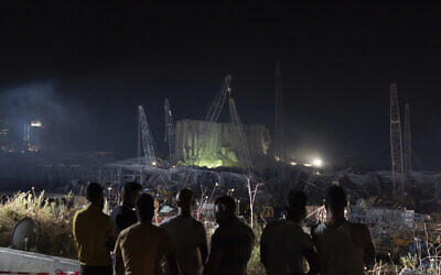 People look at the scene of Tuesday's explosion that hit the seaport of Beirut, Lebanon, Friday, Aug. 7, 2020. Rescue teams were still searching the rubble of Beirut's port for bodies on Friday, nearly three days after a massive explosion sent a wave of destruction through Lebanon's capital, killing over a hundred people and wounding thousands. (AP Photo/Felipe Dana) People look at the scene of Tuesday's explosion that hit the seaport of Beirut, Lebanon, Friday, Aug. 7, 2020. Rescue teams were still searching the rubble of Beirut's port for bodies on Friday, nearly three days after a massive explosion sent a wave of destruction through Lebanon's capital, killing over a hundred people and wounding thousands. (AP Photo/Felipe Dana)
