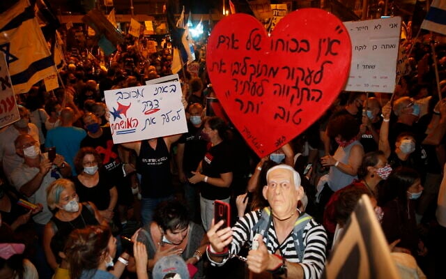 Thousands protest against Prime Minister Benjamin Netanyahu outside his official residence in Jerusalem on August 8, 2020. (AP Photo/Ariel Schalit) Thousands protest against Prime Minister Benjamin Netanyahu outside his official residence in Jerusalem on August 8, 2020. (AP Photo/Ariel Schalit)