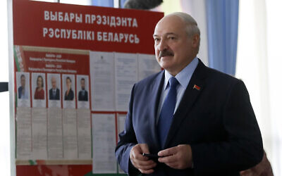 Belarusian President Alexander Lukashenko arrives to vote at a polling station during the presidential election in Minsk, Belarus, August 9, 2020. (AP Photo/Sergei Grits)