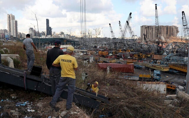 Workers remove debris from the site of last week's explosion that hit the seaport of Beirut, Lebanon, Aug. 10, 2020 (AP Photo/Bilal Hussein) Workers remove debris from the site of last week's explosion that hit the seaport of Beirut, Lebanon, Aug. 10, 2020 (AP Photo/Bilal Hussein)