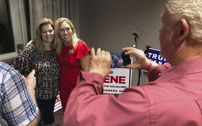 Supporters take photos with Republican conspiracy theorist Marjorie Taylor Greene, background right, in Rome, Georgia, August 11, 2020. (AP Photo/Mike Stewart)