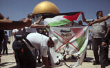 Palestinian protesters burn a banner showing Abu Dhabi Crown Prince Mohamed bin Zayed al-Nahyan near the Dome of the Rock on the Temple Mount in Jerusalem's Old City, August 14, 2020. (AP Photo/Mahmoud Illean)