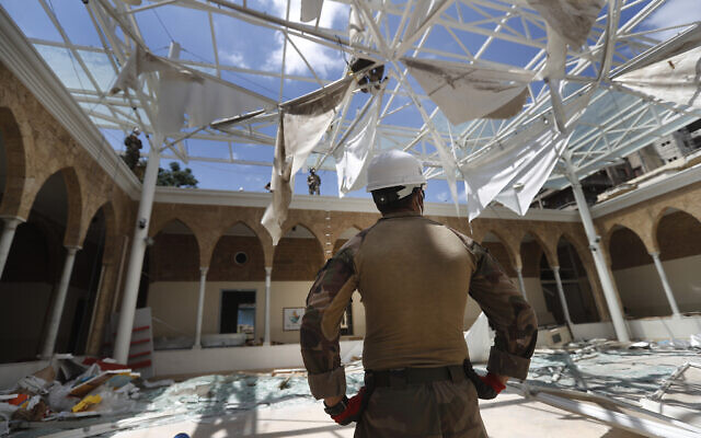 A French soldier looks at his comrades removing the debris of a school playground roof that was destroyed by Aug. 4 explosion that hit the seaport of Beirut, Lebanon, Aug. 20, 2020 (AP Photo/Hussein Malla) A French soldier looks at his comrades removing the debris of a school playground roof that was destroyed by Aug. 4 explosion that hit the seaport of Beirut, Lebanon, Aug. 20, 2020 (AP Photo/Hussein Malla)